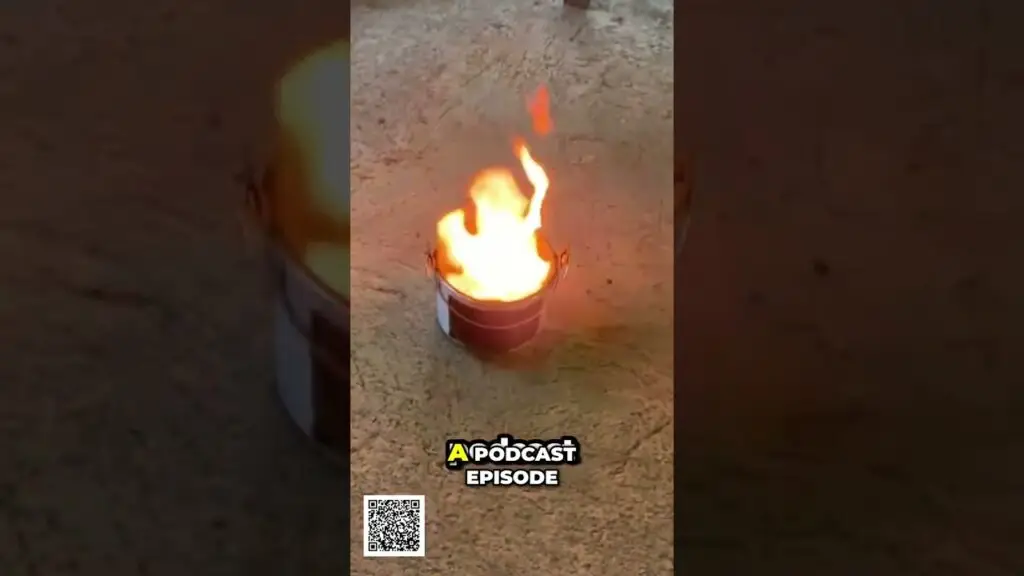 Small metal bucket with bright flames burning on a dirt ground; text 'A PODCAST EPISODE' and a QR code near the bottom.