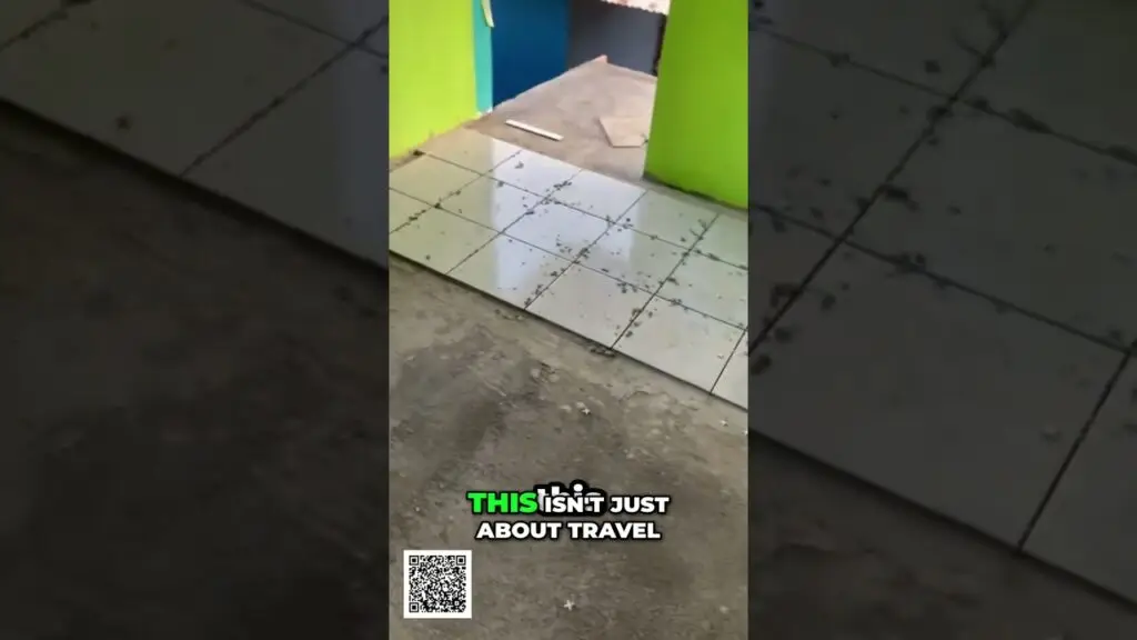 Vertical video still of a doorway with neon lime-green walls and a glossy tiled floor; a white pipe lies on the floor, with the caption “THIS ISN'T JUST ABOUT TRAVEL” and a QR code at the bottom-left.