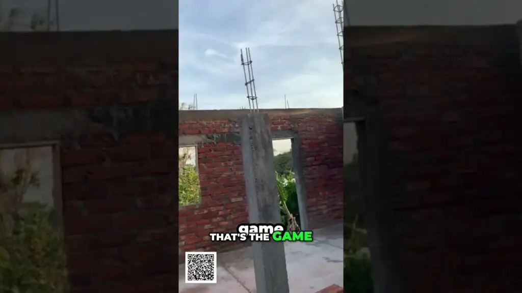 Unfinished brick building with a concrete column and vertical rebar rising above, blue sky in the background; overlay text reads 'game THAT'S THE GAME' and a QR code is visible in the lower-left corner.