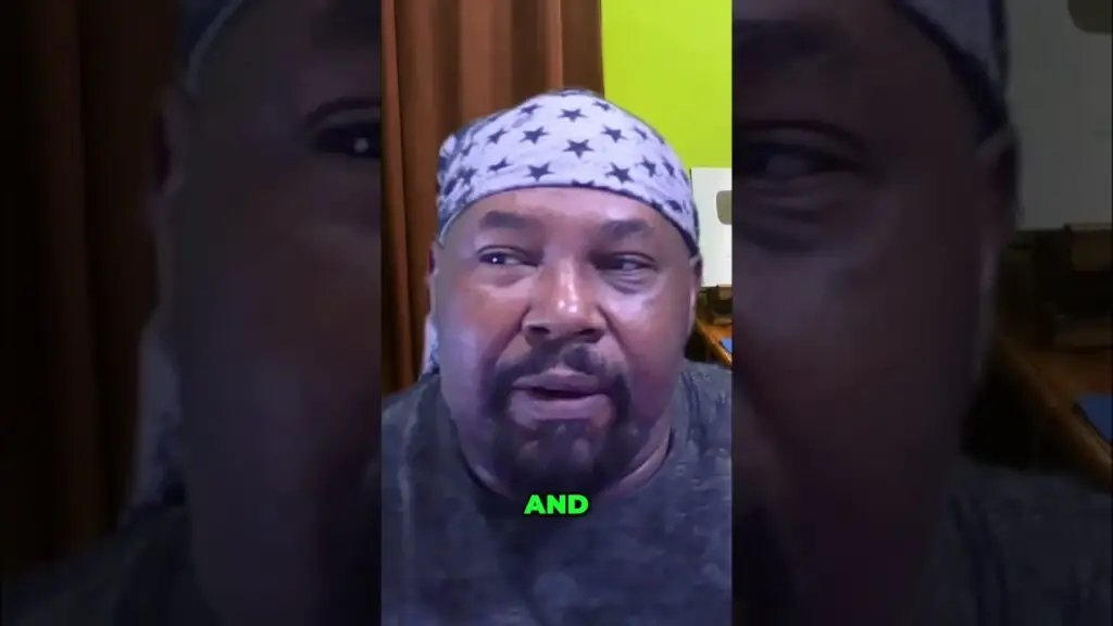 Close-up of a man wearing a star-pattern bandana, mid-speech, with a lime-green word 'AND' overlaid at the bottom.