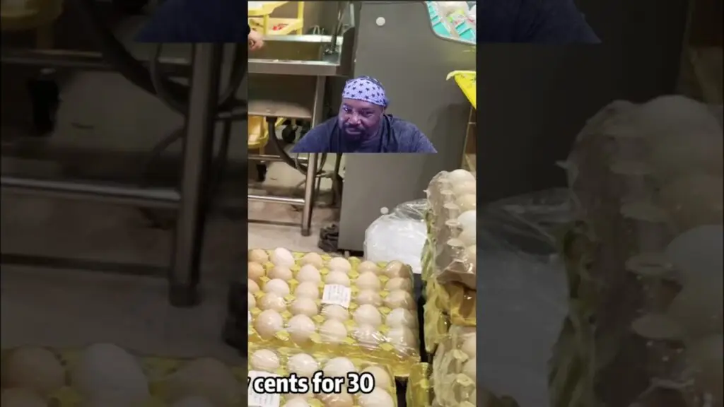 Man with a star-pattern bandana leaning over pallets of eggs in a grocery store; a price sign on the eggs shows '7 cents for 30'.
