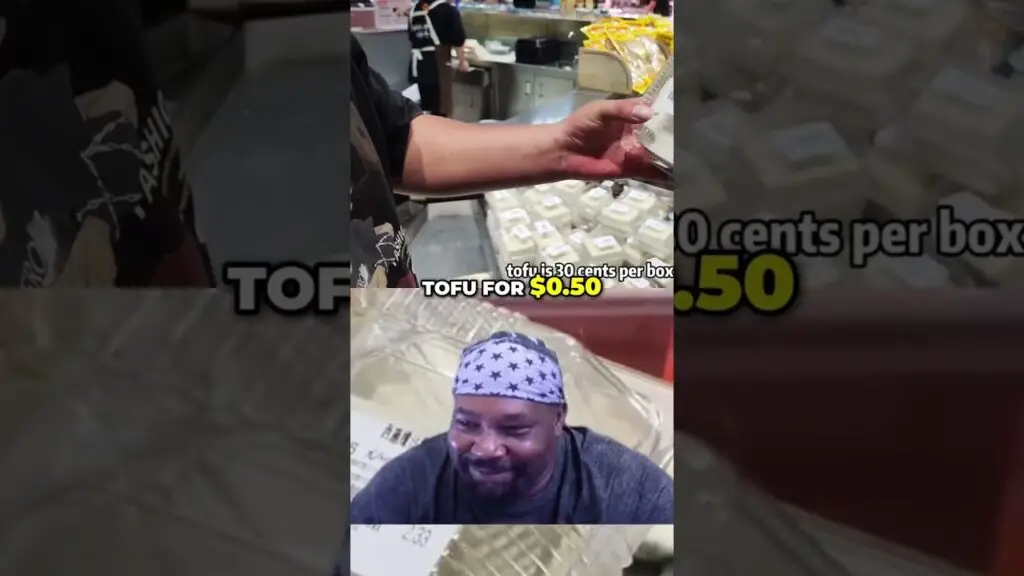 Video thumbnail: shopper in a grocery store offers tofu for $0.50; foreground shows a man in a star-pattern bandana smiling.